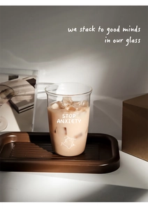 Close-up of heat-resistant glass cup with cat print and Stop Anxiety text on tray