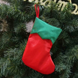 7-inch red and green satin Christmas elf stocking hanging on a decorated festive tree