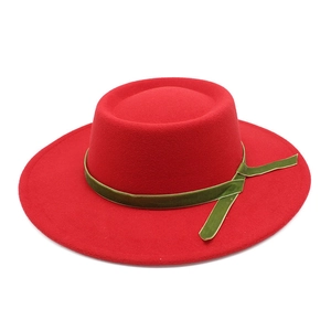 Detail of red wool felt fedora featuring an olive green velvet decorative ribbon band