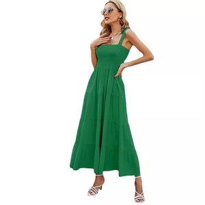Elegant green smocked maxi dress with tiered skirt and bow tie straps for summer wear
