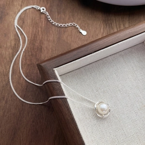 Elegant S925 sterling silver necklace featuring a white pearl and minimalist silver ring pendant