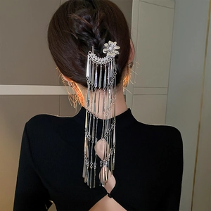 Detail of silver floral hair stick with long tassels and sparkling diamond center