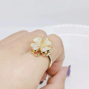 Macro shot of gold-tone spinning clover ring with cubic zirconia micro-pave setting