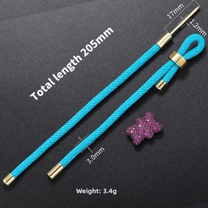 Detailed view of DIY blue braided rope bracelet with pink bear charm and 205mm size label