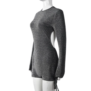 Close-up of silver sequin jumpsuit showing side open back detail and glitter fabric