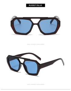 Macro detail of geometric russet frame and blue lenses on double bridge sunglasses