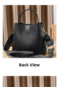 Detail view of the black woven bucket bag showing its texture and geometric strap