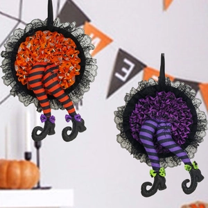 Detail of orange and purple striped witch leg wreaths with lace skirts for Halloween