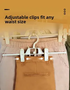 Close-up of adjustable clips on a multifunctional pant hanger for varied waist sizes