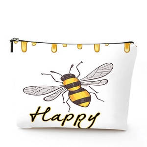 Detailed close-up of a linen makeup bag featuring a cartoon bee and Happy text print