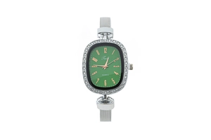 Detailed close-up of oval green dial watch with rhinestone bezel and silver mesh strap