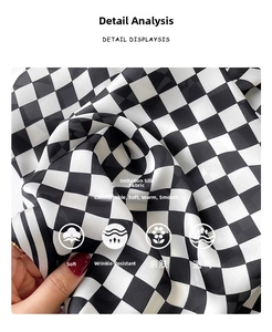 Detail of silk-like checkerboard scarf fabric showing soft texture and glossy finish