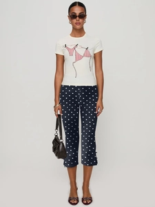 Women's white T-shirt with bikini print and navy polka dot cropped flare pants