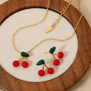 Cute red cherry pendant necklace and earrings set in gold finish stainless steel