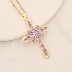 18K gold plated cross necklace with purple zircon stones on a beige background