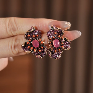 Vue macro détaillée des boucles d'oreilles fleurs vintage avec incrustation de gemmes