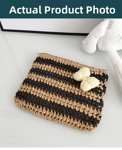 Detail of striped crochet straw envelope clutch with an ivory woven bow decoration