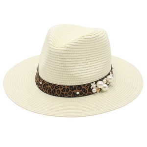Detail of Panama straw hat featuring leopard print ribbon with pearls and 3D floral accents