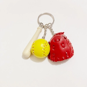 Detailed close-up of baseball keychain with mini wooden bat, yellow ball, and red glove