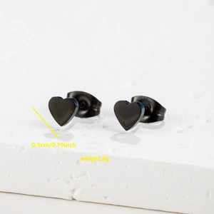 Detailed macro view showing black heart stud earrings size 0.5cm and butterfly backing