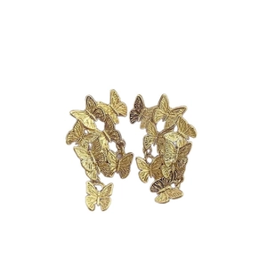 Retro golden butterfly stud earrings with layered multi-wing design on white background