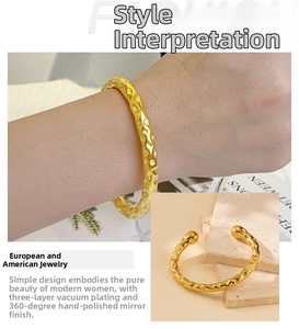 Detailed view of 18K gold plated cuff with irregular hammered texture and mirror polish