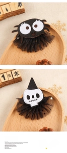 Detail of Halloween spider and skull mesh hair clips on a wooden tray for cosplay decor