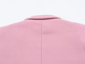 Detailed close-up of the back neckline and seams on a pink wool oversized blazer