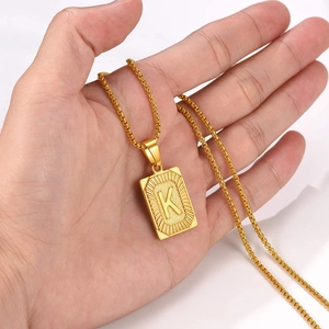Gold initial necklace with letter K rectangular pendant on a Cuban chain for men and women