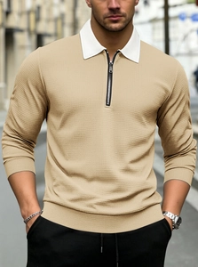 Detail of men's beige waffle knit polo shirt showing contrast collar and zip neckline