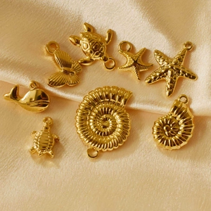 Golden stainless steel ocean sea turtle starfish charms set on silk fabric