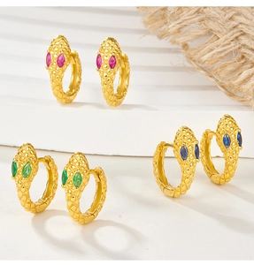 Macro detail of snake-shaped earrings with colorful zircon stones and scale texture