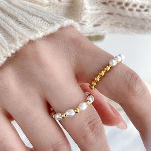 Freshwater pearl pea ring with crossed gold steel leaf lines and beads in open design
