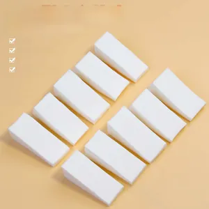 Macro shot of 10-piece white high-density foam wedges for nail art gradient effects