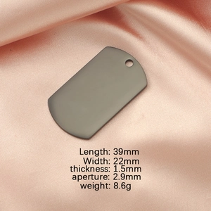 Macro view of gun black matte stainless steel dog tag with size and weight specifications