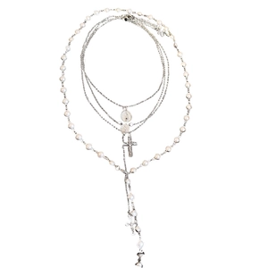 Layered silver pearl necklace with cross pendant and beads in stylish minimalist design