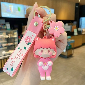 Pink sakura girl keychain with cat ears, cherry blossom charm and silicone wrist strap