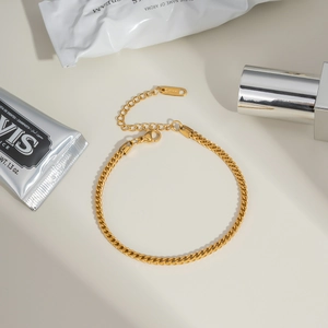 Detailed view of a gold-plated dragon chain bracelet with adjustable clasp and extension chain