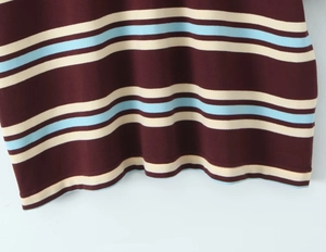 Detail of striped piqué fabric on a short sleeve top showing texture and hem