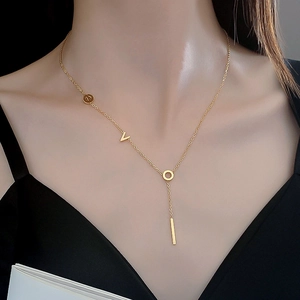 Minimalist gold titanium steel necklace with V-letter and round pendant on a model