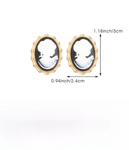 Detail view of vintage cameo stud earrings with resin portrait and gold metal frame