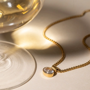 Detail of 18K gold stainless steel box chain with round white zircon pendant