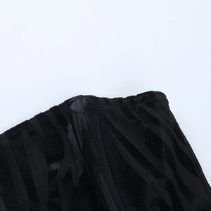 Detailed macro view showing the black flocked striped fabric and stitching of the corset top
