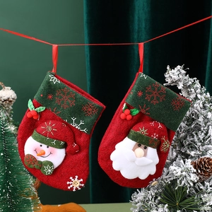 Rustic Christmas stockings with Santa and Snowman hanging by a snowy tree