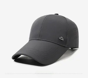 Detail of dark gray quick-dry baseball cap featuring laser-cut vents and mountain logo
