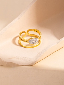 Detail of adjustable gold double-layer star ring with hollow chain and micro diamonds