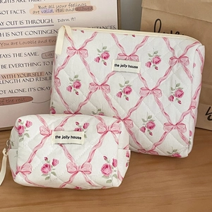 Quilted cotton toiletry bag set with pink rose and bow print on cream background