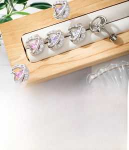 Detail view of heart-shaped zircon moon stud earrings in silver titanium steel