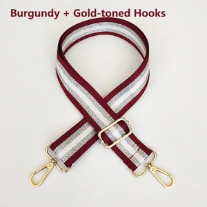 Adjustable burgundy and silver striped nylon bag strap with gold metal hardware