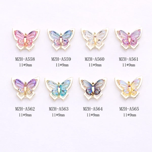 Eight colorful alloy butterfly nail charms with gold edges and gradient resin crystals